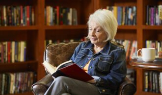 woman reading book in library