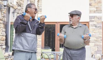 two men lifting weights outside