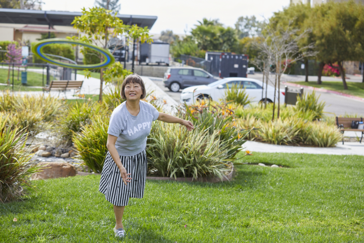 Woman happily throwing frisbee