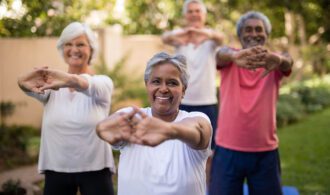 a group of elderly people stretch outside