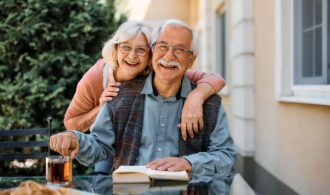an elderly couple smiles while reading a book, Paradise Village, Southern California