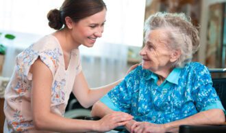 an elderly woman is cared for by a staff member