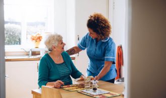 Assisted Living caregiver talks with resident